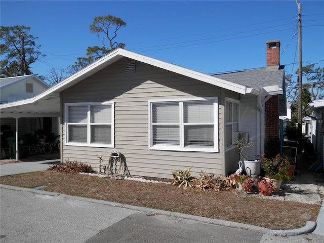 view of home's exterior featuring a carport