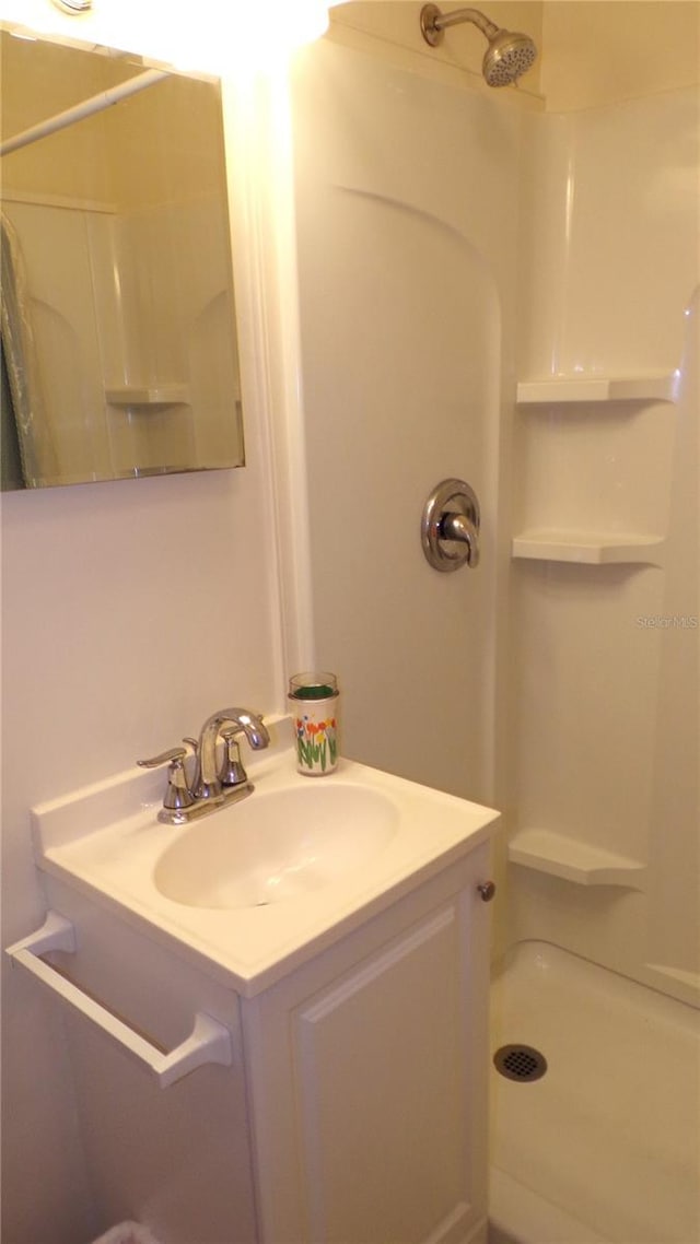 bathroom with vanity and walk in shower