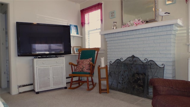 living room featuring light carpet, a baseboard heating unit, and a fireplace