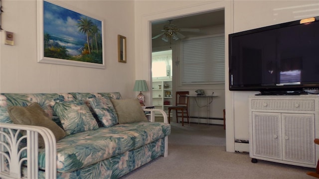 carpeted living room featuring a baseboard heating unit and ceiling fan