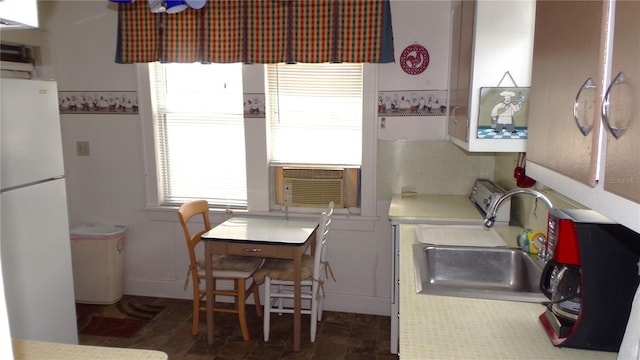 kitchen with white refrigerator, sink, and cooling unit