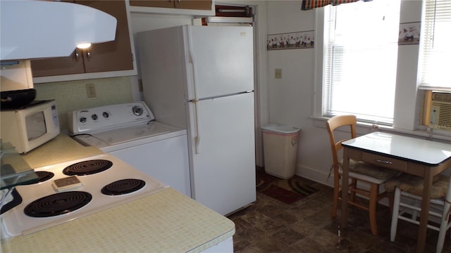 kitchen featuring washer / clothes dryer and white appliances