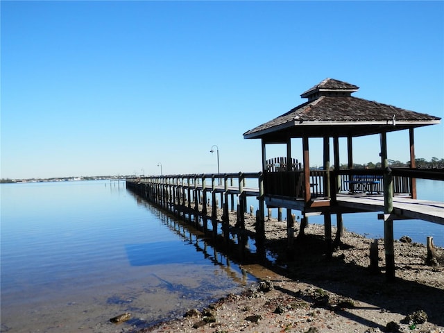 dock area with a gazebo and a water view