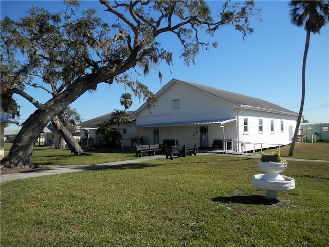 rear view of property with a lawn