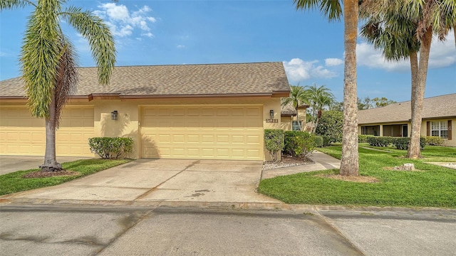 ranch-style home featuring a front lawn and a garage