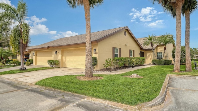 ranch-style house featuring a front yard and a garage