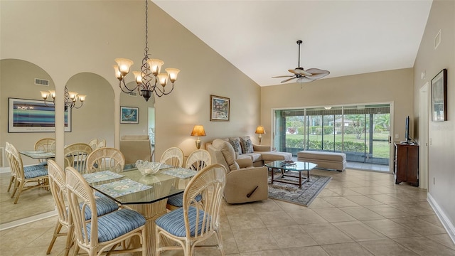 dining room featuring light tile patterned floors, ceiling fan with notable chandelier, and high vaulted ceiling