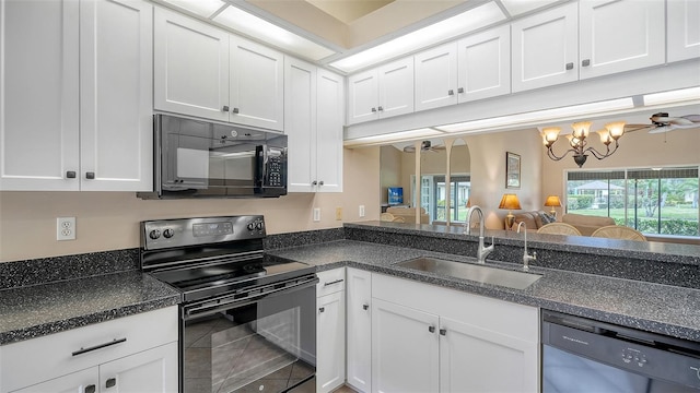 kitchen featuring tile patterned flooring, black appliances, sink, white cabinetry, and ceiling fan with notable chandelier