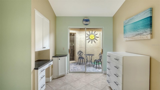 interior space with white cabinets and light tile patterned floors