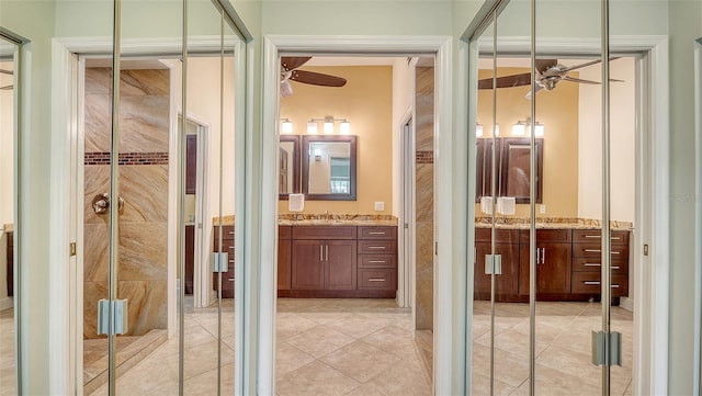 bathroom featuring tile patterned floors, an enclosed shower, and vanity