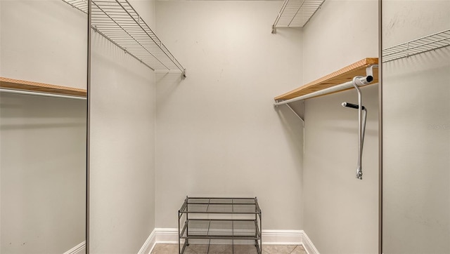 spacious closet featuring light tile patterned flooring