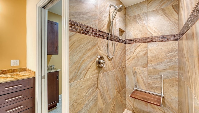 bathroom featuring vanity and a tile shower