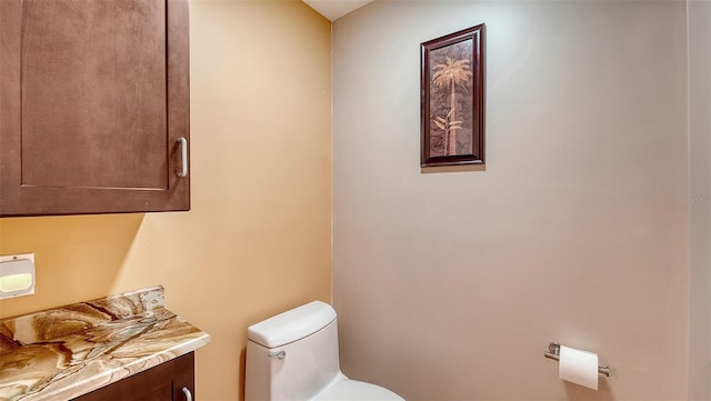 bathroom featuring toilet and vanity