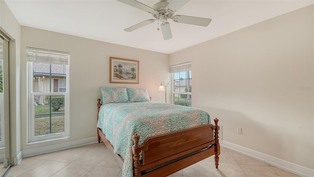 tiled bedroom featuring ceiling fan