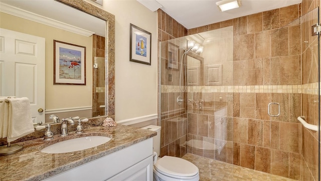 bathroom with toilet, ornamental molding, walk in shower, and vanity