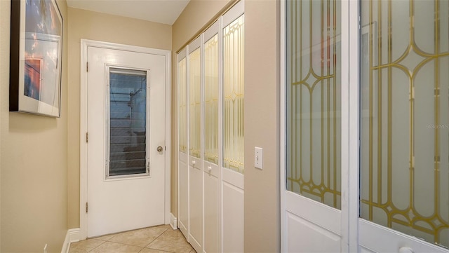 doorway to outside featuring light tile patterned flooring