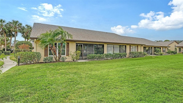 back of house with a lawn