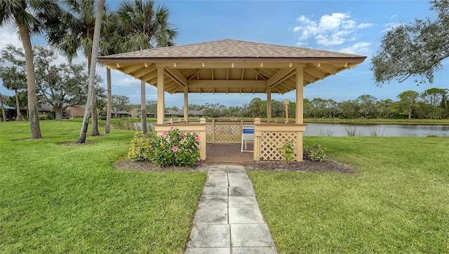 view of community with a gazebo, a lawn, and a water view