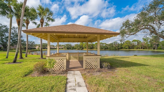 view of property's community with a gazebo, a yard, and a water view