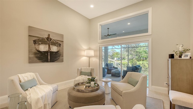 sitting room featuring ceiling fan and lofted ceiling