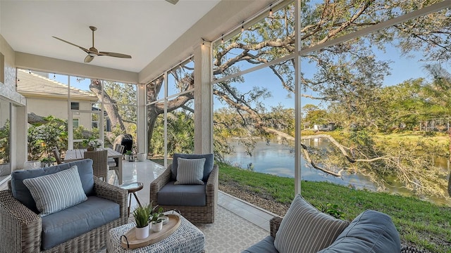 sunroom featuring a water view, ceiling fan, and a wealth of natural light