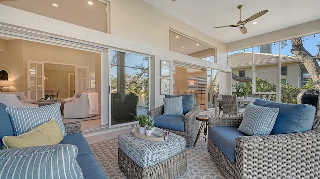 sunroom / solarium featuring ceiling fan and french doors