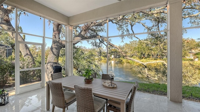 sunroom featuring a wealth of natural light and a water view