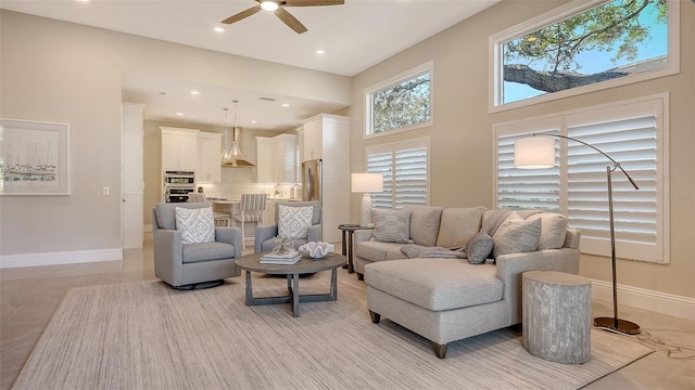 tiled living room featuring ceiling fan and a towering ceiling