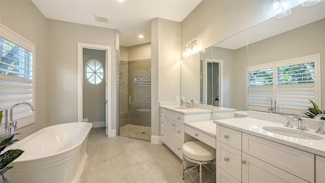 bathroom with plus walk in shower, tile patterned floors, and vanity