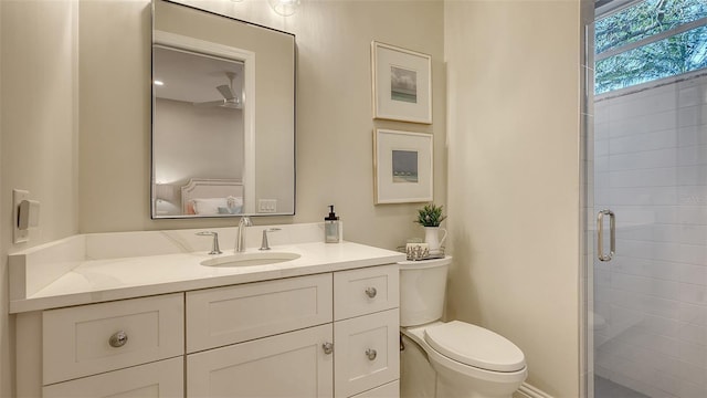 bathroom featuring walk in shower, vanity, and toilet