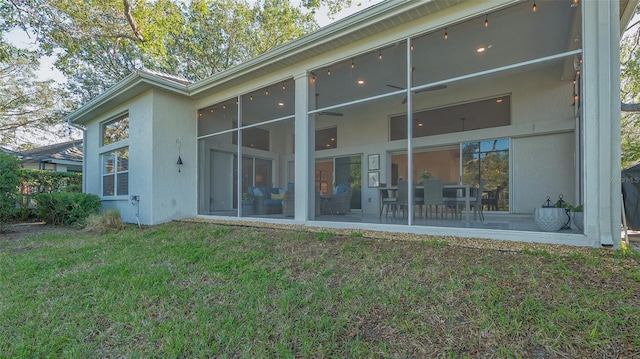 rear view of property featuring a patio area and a lawn