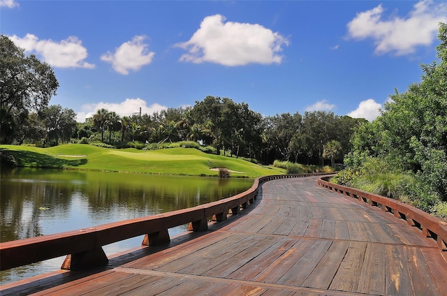 surrounding community featuring a water view and a yard