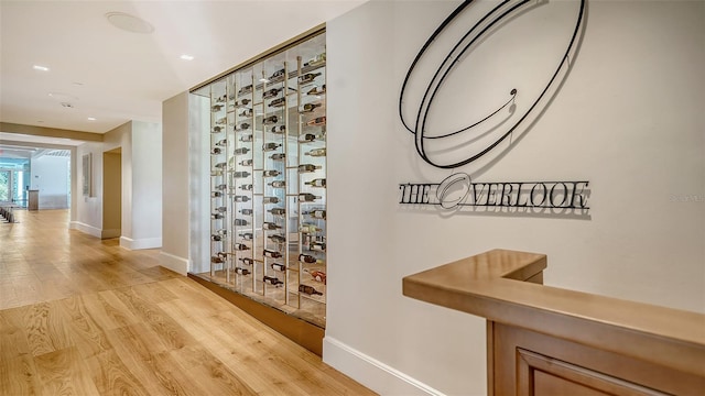 hallway with hardwood / wood-style flooring