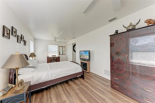 bedroom with ceiling fan and light hardwood / wood-style floors