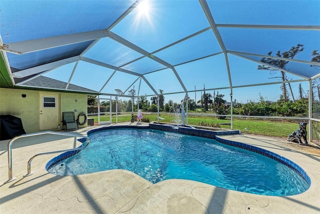 view of swimming pool featuring glass enclosure and a patio