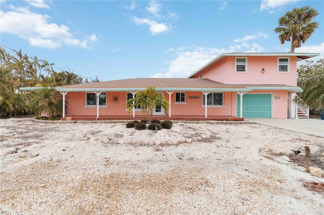 view of front of property with a porch and a garage