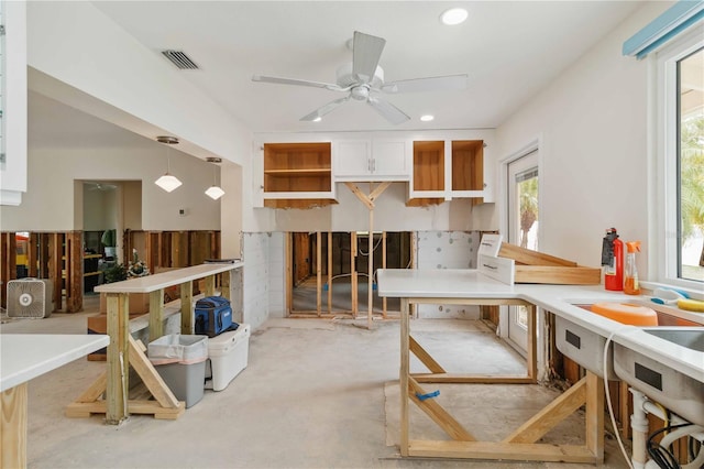 kitchen with ceiling fan and decorative light fixtures