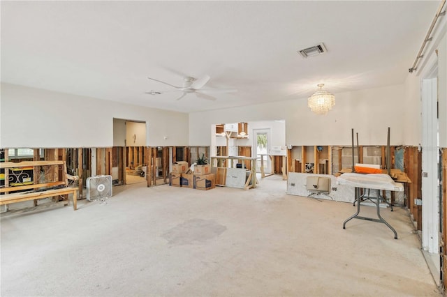 miscellaneous room with ceiling fan with notable chandelier