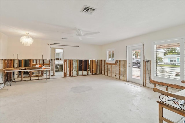 miscellaneous room with ceiling fan with notable chandelier