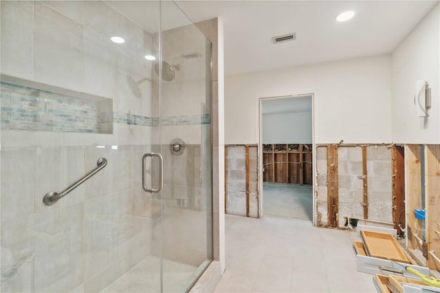 bathroom featuring an enclosed shower and tile patterned floors