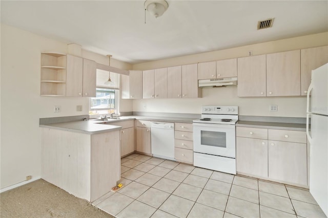 kitchen featuring sink, white appliances, hanging light fixtures, light carpet, and kitchen peninsula