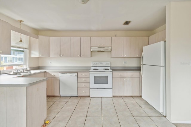 kitchen with white appliances, sink, hanging light fixtures, and light tile patterned floors