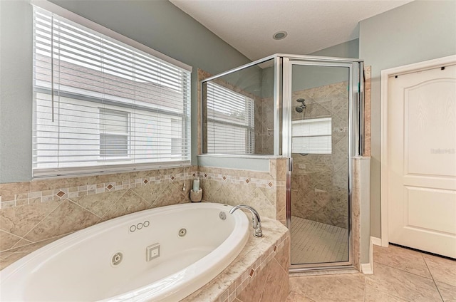 bathroom with independent shower and bath and tile patterned floors