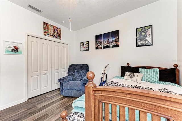 bedroom with wood-type flooring and a closet