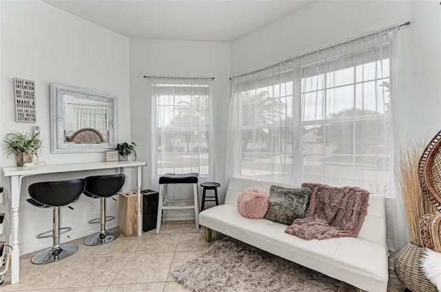 living area featuring light tile patterned floors and plenty of natural light