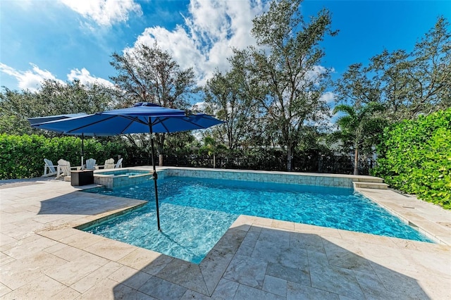 view of pool with a patio and an in ground hot tub