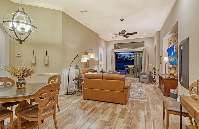 living room featuring crown molding, ceiling fan with notable chandelier, and light hardwood / wood-style flooring