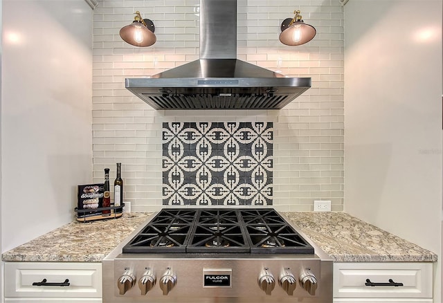 kitchen featuring tasteful backsplash, gas cooktop, island exhaust hood, white cabinetry, and light stone counters