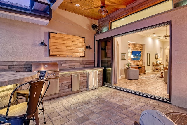 view of patio featuring ceiling fan, an outdoor kitchen, and area for grilling