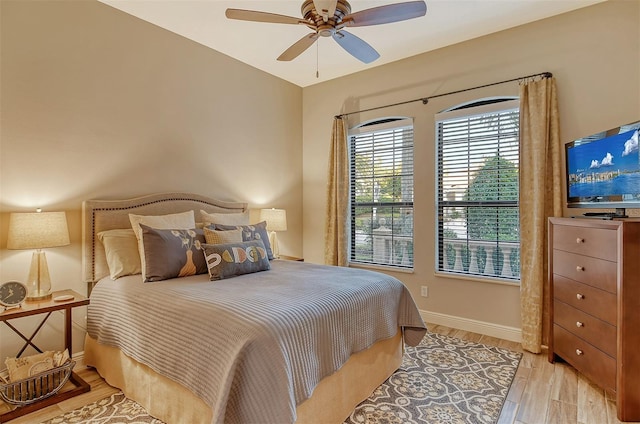 bedroom with ceiling fan and light hardwood / wood-style floors